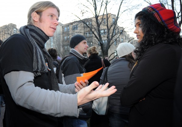 Tuesday, Dec. 1, 2009-Marsh Chapel Associate Jeff Dodge (left) invites Boston University student Meena Iyer (right) to the Prayer of Forgiveness Marsh Chapel's LGBTQ Ministry held Tuesday night. The LGBTQ Ministry organized a Love Picnic at the Florence Chafetz Hillel House at 213 Bay State Rd., Boston, Mass. in response to the Westboro Baptist Church's anti-gay protest that day. | Photo by Casey Germann.
