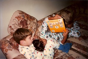 The author reading a book (slowly) to her brother