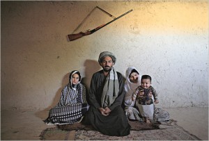 13-year-old girl sits with her 45-year old husband, his first wife and their child. Photo by Stephanie Sinclair. / Courtesy of user Jason Drakeford, Via Flickr Commons
