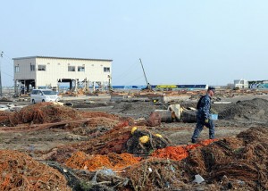 A sailor walks through debris in the aftermath of the catastrophic earthquake and subsequent tsunami of 2011 in Misawa, Japan.  |  Photo courtesy of the Official Navy Page.