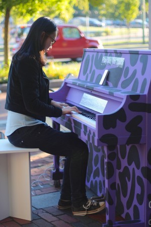 Rainie Tang (CAS'17) treats bystanders to a song read off of her iPhone - Photo by Hanna Klein