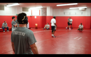 Wrestlers listen in on Coach Carl Adam's instructions during practice.