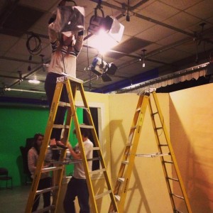 A production assistant helps with lighting| Photo courtesy of Stephanie Semet--Former Bay State PR Coordinator