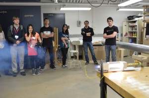 The group fires a small, acrylic rocket motor in their lab as a demonstration to a tour of admitted students. Photo by Jake Lucas