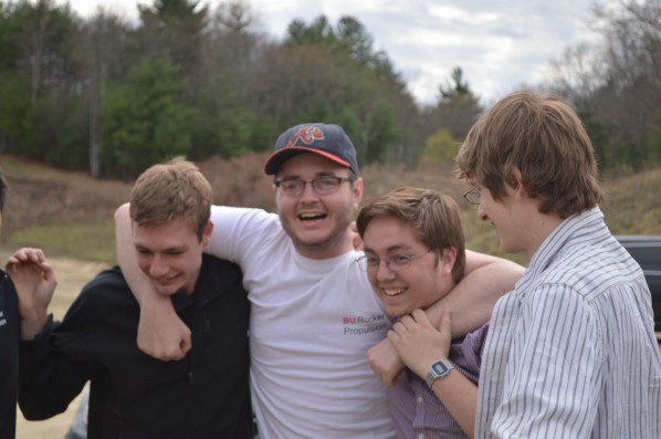 From left to right: Armor Harris, Drew Kelley and Tom Halstead hug after a successful fire. Photo by Jake Lucas