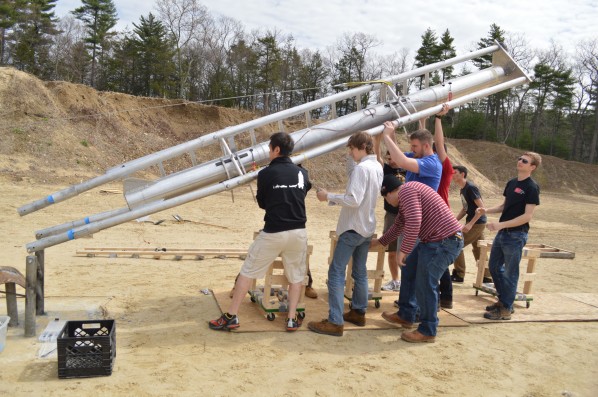 Members of the rocket propulsion group hoist the rocket onto its test stand. Photo by Jake Lucas.